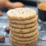 Swedish Hazelnut & Cardamom Cookies in a stach, with bits of cardamom on top.