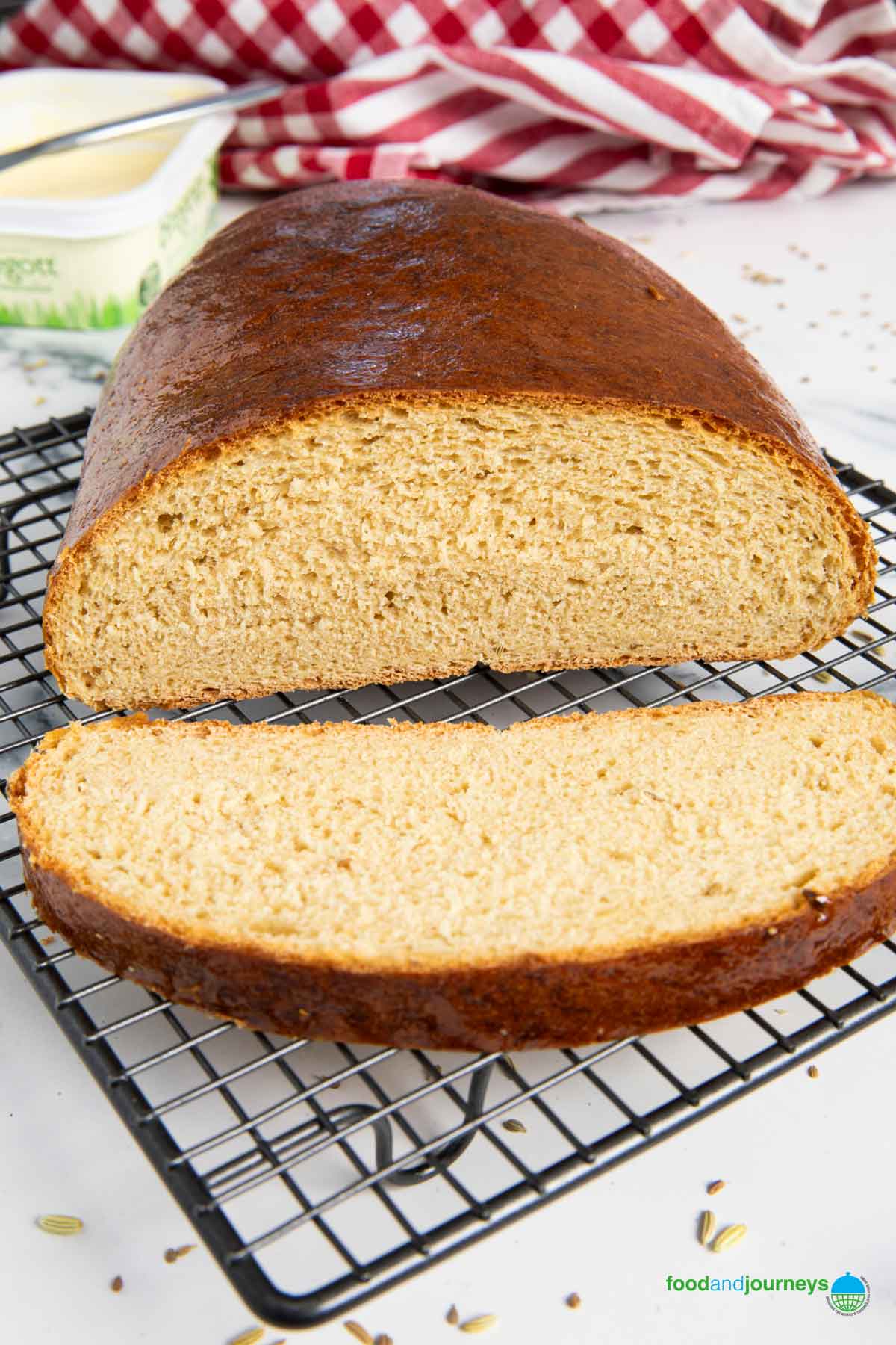 A sliced loaf of sirapslimpa with a butter on the background.