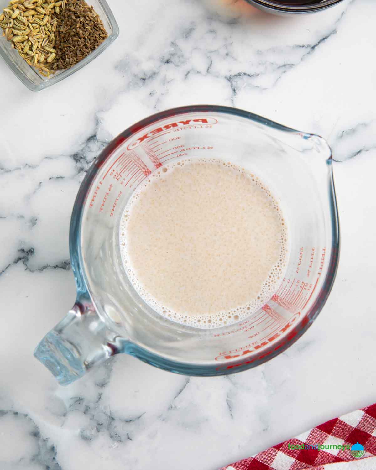 Mixing yeast with water as the first step in making a syrup loaf.