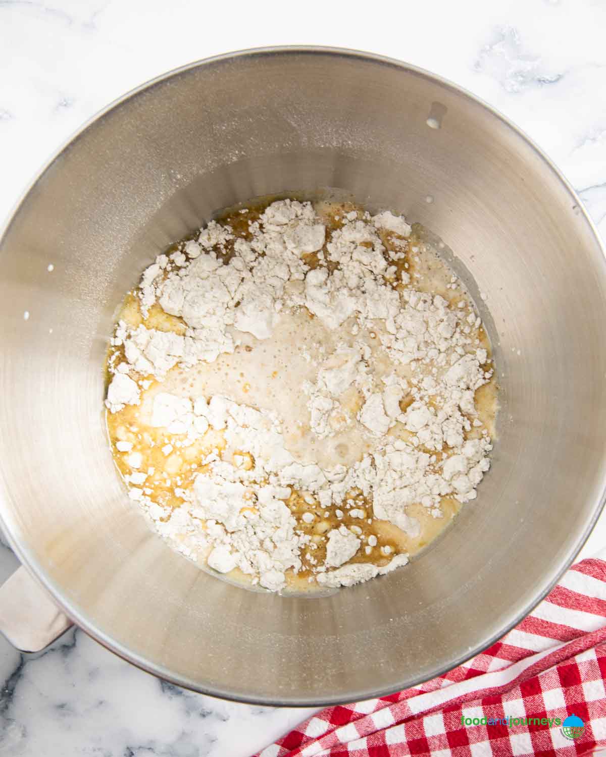 All the ingredients of an authentic Swedish limpa bread in a stand mixer bowl.