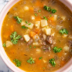A bowl of German oxtail soup, garnished with parsley.