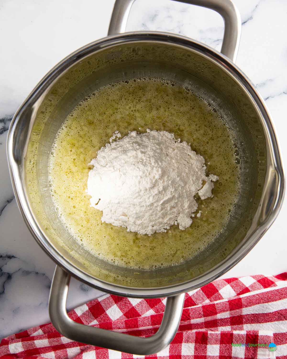 Adding flour in the roux after sautéing the onions.