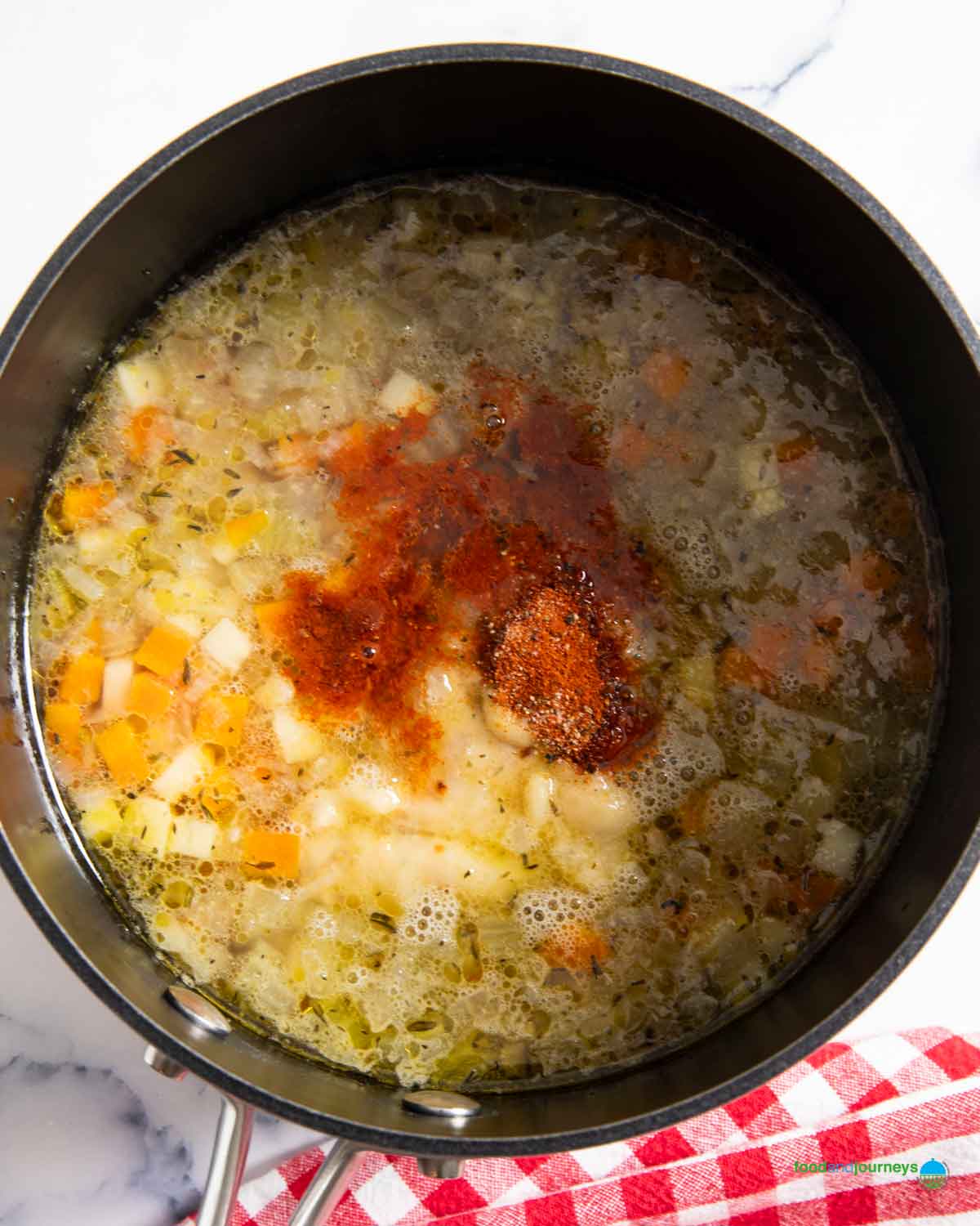 Adding the paprika and other seasoning after hours of simmering the oxtail soup from Germany.