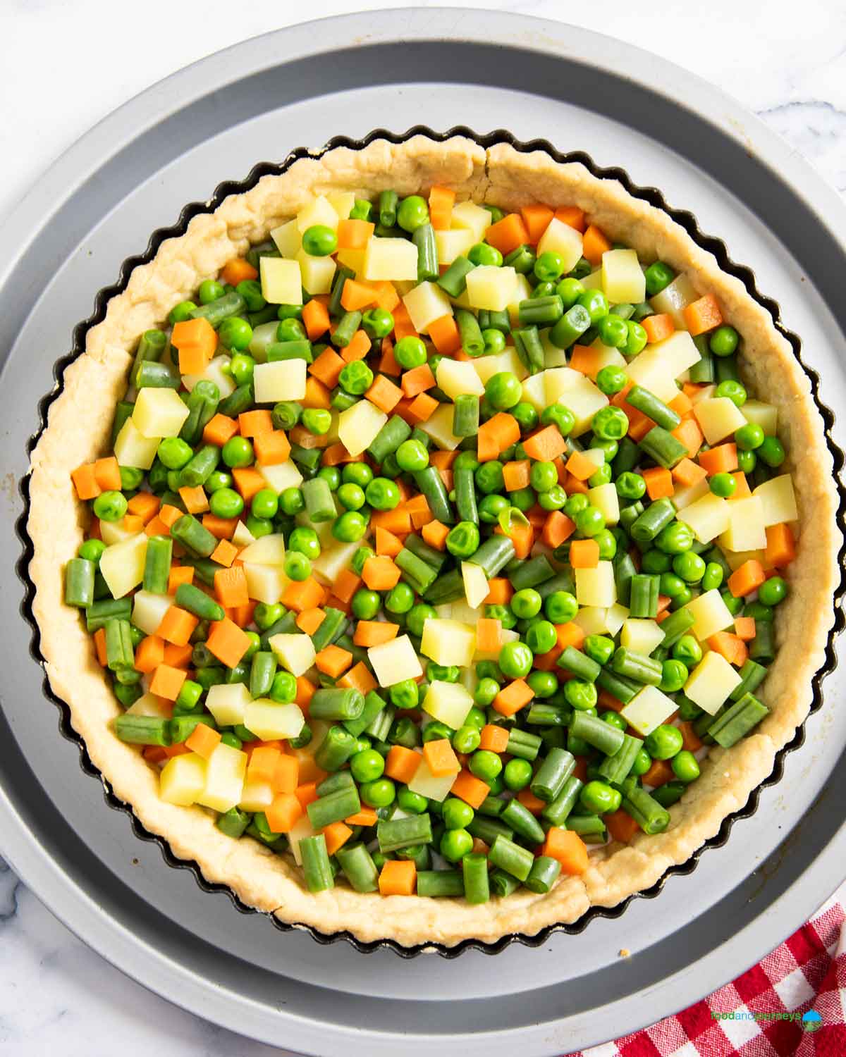 Arranging the blanched vegetables in the pastry, seasonal vegetables in France.