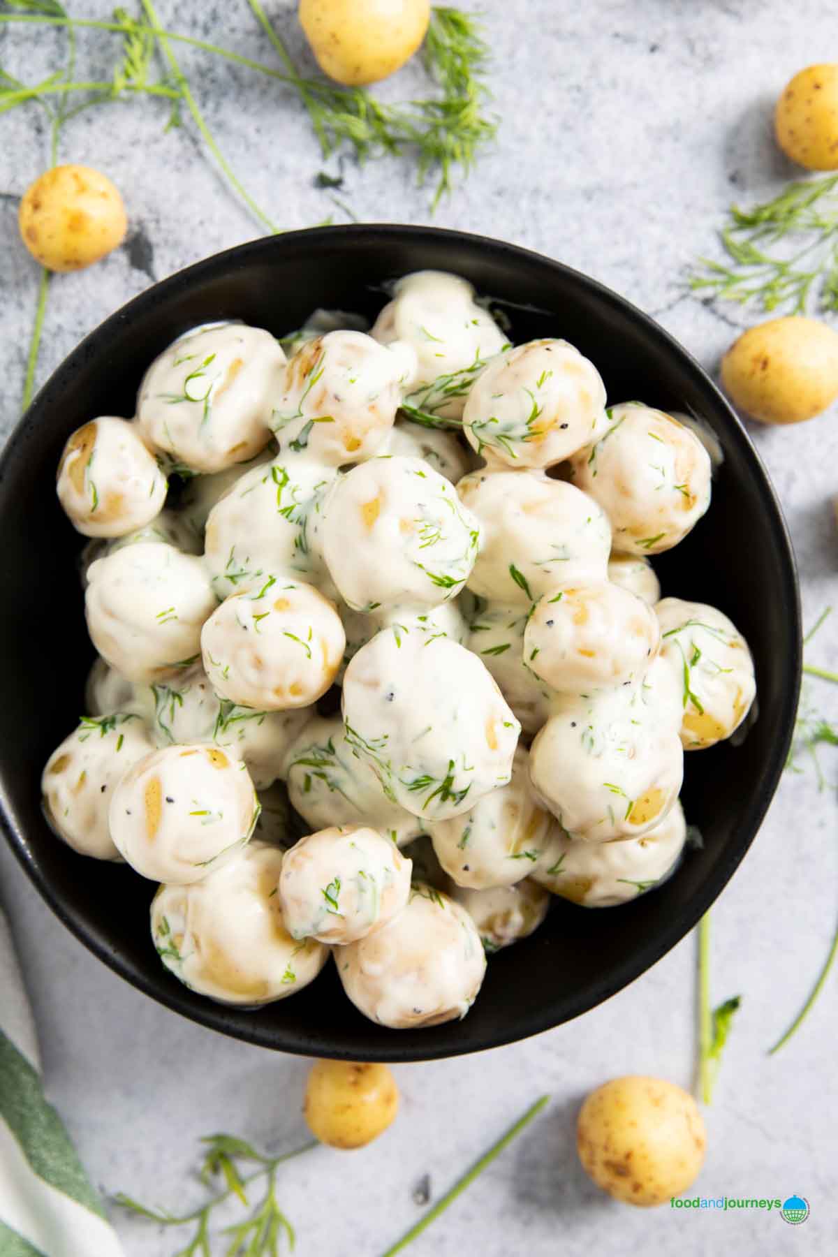 An overhead shot of potatoes with dill sauce, a classic Swedish dish.