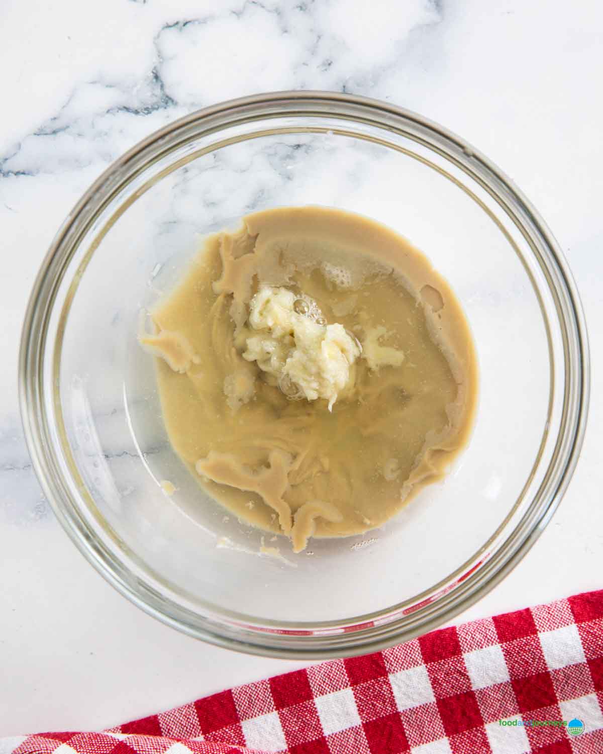 Mixing the tahini with lemon juice and garlic paste to amp up the smokiness of the roasted eggplants.