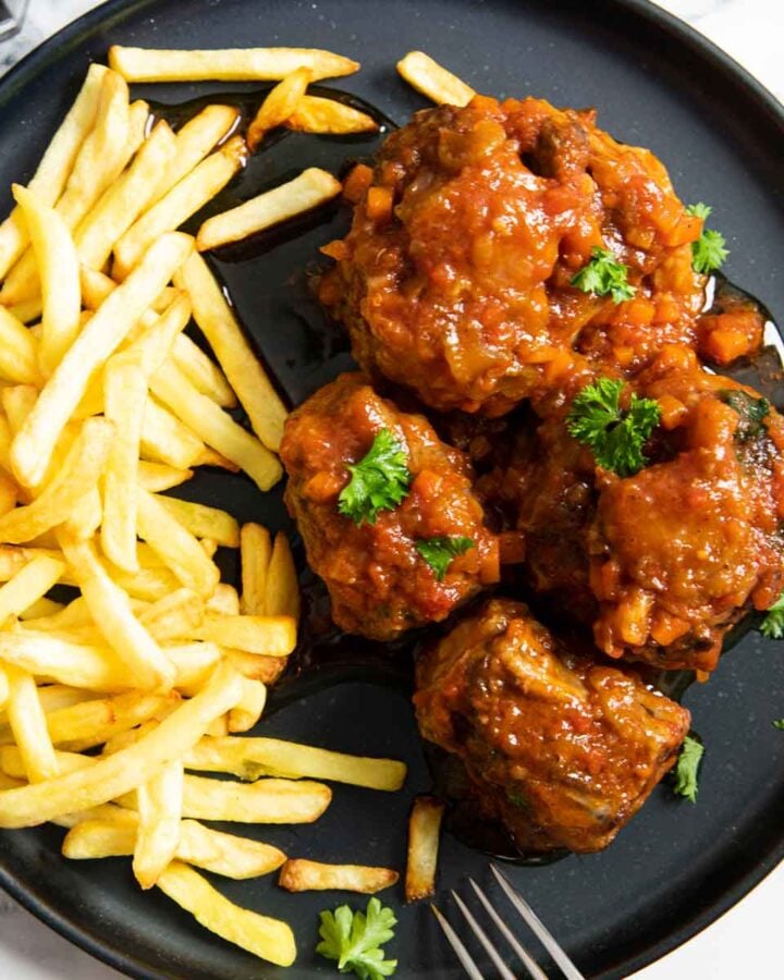 A serving of rabo de toro, showing how its traditionally served in Malaga, with French fries.