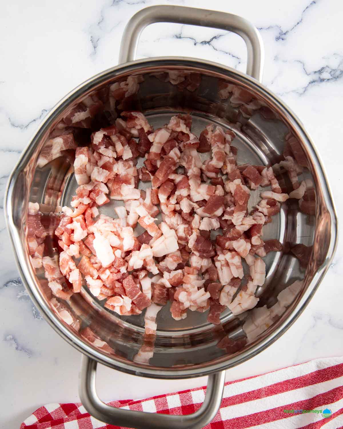 Chopped bacon cooking in a saucepan for traditional German pea soup.