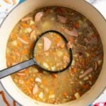 A ladle of lentil soup from Germany, ready for transferring into bowls.