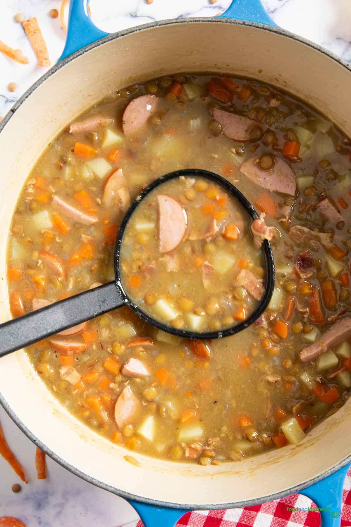 A ladle of linsensuppe, ready for transferring into serving bowls, and garnishing before serving.