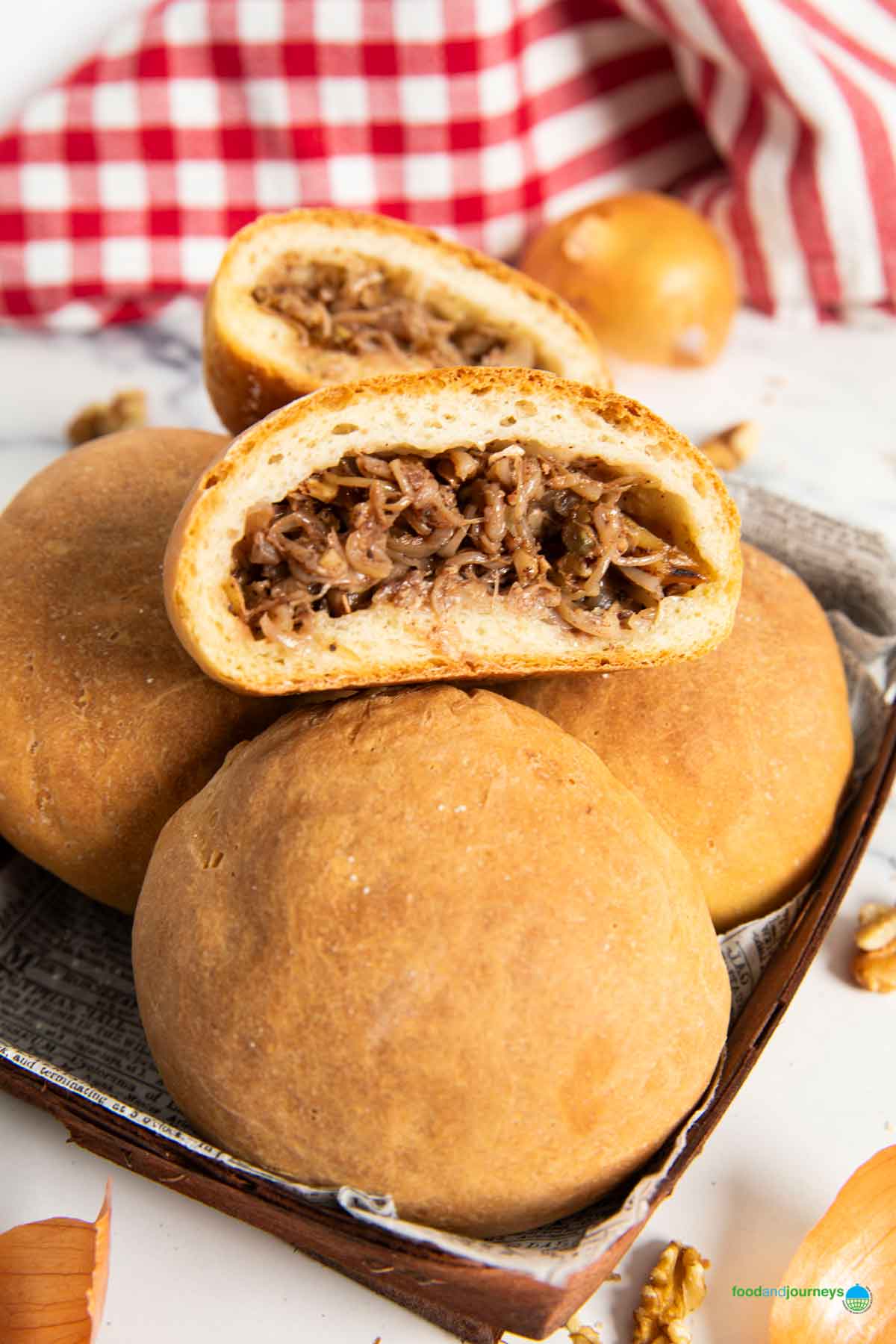 A closer shot of the inside of the Lebanese savoury bun, showing the onions and walnuts as filling.