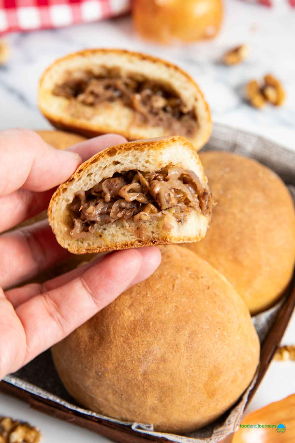 A small portion of a Lebanese savoury bread showcasing the filling made of onions and walnuts.