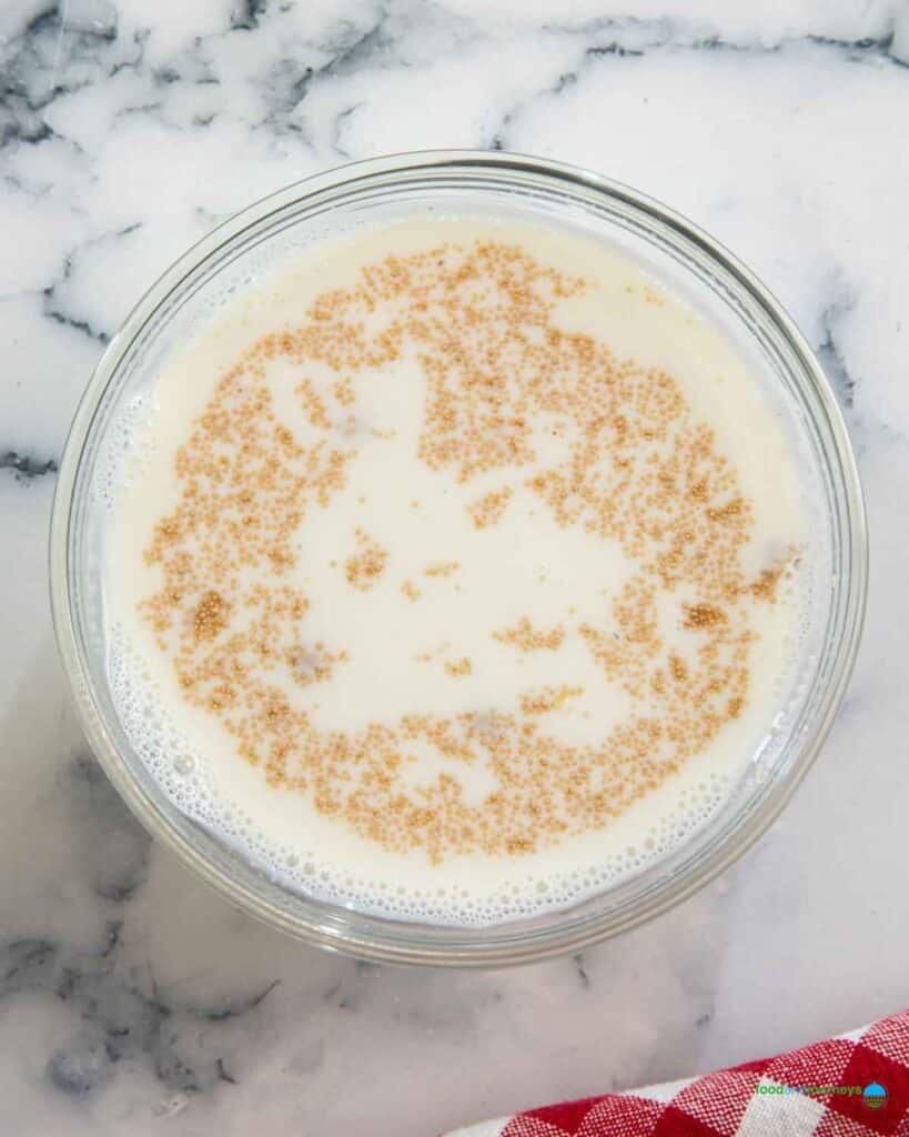 Combining warm milk with yeast is the first step in preparing this Lebanese stuffed bread at home.