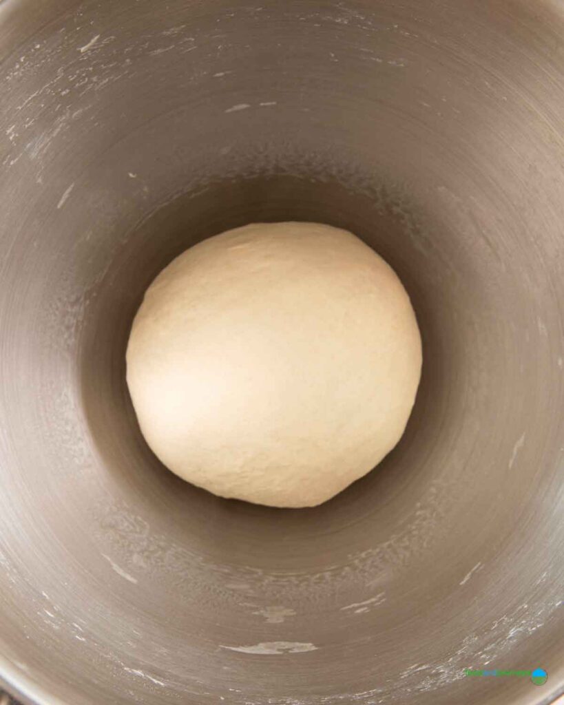 A smooth ball of dough is set aside for first proofing, before forming it into Lebanese bread with onions and walnuts.